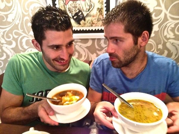 Stefan eating solyanka soup and Sebastien with ukha soup