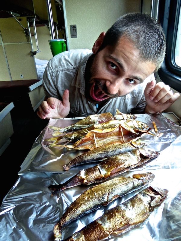 Seb about to go face down in our smoked omul fish purchased on the Trans Siberian train