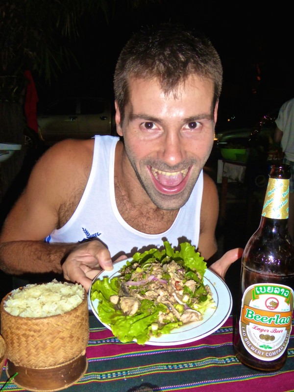 Seb enjoying buffalo laap with sticky rice and a Beerlao