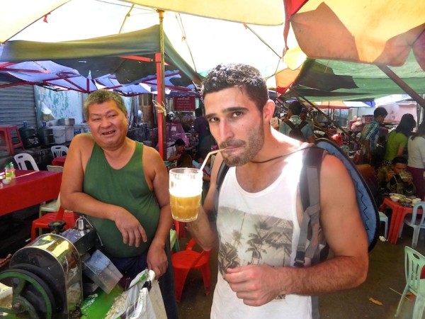 Stefan tucking into sugar cane juice drink