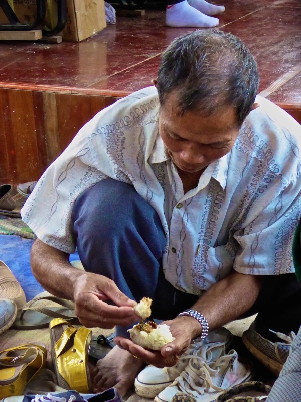 Man eating sticky rice with fingers