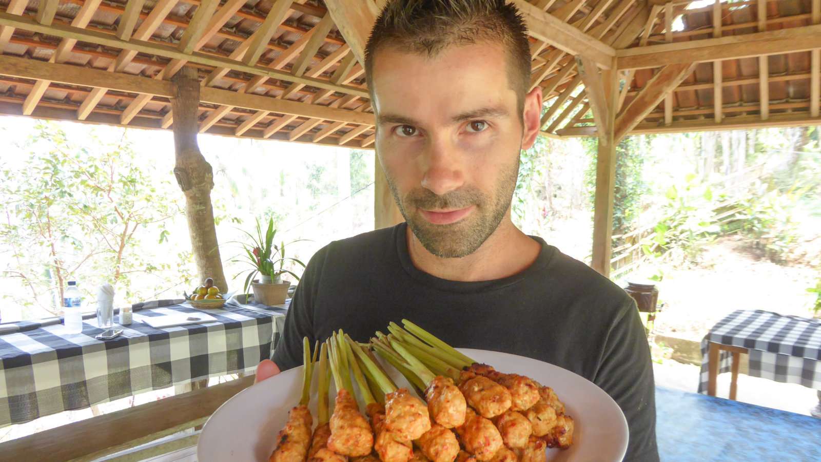 Sebastien proudly showing off his freshly made lemongrass chicken satay sticks